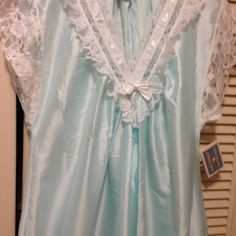 Gilligan O'malley Beautiful Night Gown Trimmed With Lace. Pale Aqua Blue With White Lace, At Neckline, Bodice, Sleeves And Hem Line. Size Is Small. 100 % Polyester, But The Look And Feel Of Satin. Hemline Is A Semi-Circle Style, Forming A V Design. Length Is 47 Inches At Center. Simply Beautiful ! ! New With Tags. Blue Sleepwear For Wedding Night In Spring, Blue Satin V-neck Nightgown, Light Blue Sleepwear For Wedding Night In Spring, Blue Lace Trim Nightgown For Pajama Party, Blue Satin Nightgown For Bedtime, Blue Satin Nightgown For Wedding Night, Beautiful Nightgown, V Design, Pale Aqua