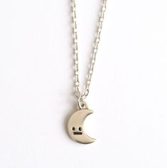 Hello little crescent moon :) This little guy likes to be worn everyday so that he knows what's going on.... Handmade in sterling silver the moon pendant features the classic RockCakes face with black diamond eyes. The moon is 12mm in tall and has a shiny polished finish. The two black diamond eyes are brilliant cut round diamonds and he has a blackened mouth detail. The chain is a simple sparkly trace chain and measures 18 inches. It fastens with a secure lobster clasp. The necklace can be made Sterling Silver Moon Charm Necklace For Everyday, Everyday Sterling Silver Charm Necklace With Moon Charm, Everyday Moon Shape Sterling Silver Charm Necklace, Everyday Moon Shaped Sterling Silver Charm Necklace, Everyday Sterling Silver Moon Charm Necklace, Moon Jewellery, Full Moon Necklace, Diamond Eyes, Daily Jewelry