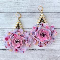 Shabby chic flower and pearl drop statement earrings that will complement so many wardrobe options! Magenta, buttery yellow, and soft lilac striped silk rosette with frayed edges mounted on 2-Inch teardrop metal filigree pieces in antique bronze finish. A metal rose given a blush with hints of magenta patina sits nested in the center of the silk rose. A pearl border finishes these feminine yet eye-catching statement earrings in the fashion's current popular teardrop shape. These accessorize with Chic Pink Flower Earrings For Spring, Handmade Feminine Flower Earrings For Spring, Handmade Feminine Flower Earrings For Party, Handmade Feminine Earrings For Spring, Bohemian Flower Earrings For Summer Wedding, Vintage Pink Earrings For Summer, Elegant Spring Flower Earrings With Floral Print, Handmade Flower Earrings For Spring Wedding, Elegant Floral Print Flower Earrings For Spring