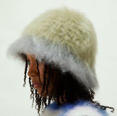 a close up of a person wearing a hat with dreads