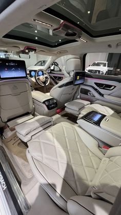 the interior of a luxury car with all white leather seats and dashboards is shown