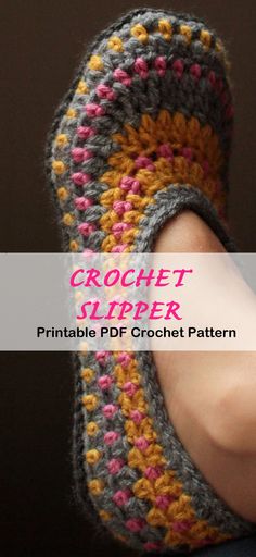 the crochet slipper is made from two different colors and has a hand holding it