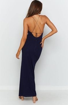 the back of a woman wearing a blue dress with spaghetti straps and low cut neckline