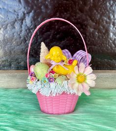 a pink basket filled with lots of flowers