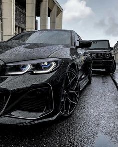 two black cars parked next to each other on the street