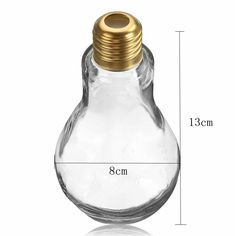 an empty glass bottle with a gold cap on the top and measurements for each one