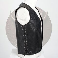 Handmade Leather Waistcoat with Side Lacing Add a touch of timeless style to your wardrobe with this handcrafted leather waistcoat. Made from high-quality black leather, this vest features adjustable side laces for the perfect fit and a unique look. It's designed to be comfortable, durable, and versatile--whether you're dressing up for a special event, rocking a festival, or just adding an edge to your everyday style. The minimalist design makes it suitable for both men and women. It's perfect f Fitted Leather Biker Vest, Black Leather Motorcycle Vest, Men’s Leather Vest, Black Leather Vest Vintage, Leather Sleeveless Vest For Motorcycling, Leather Waistcoat, Leather Vest, Biker Style, Vest Outfits