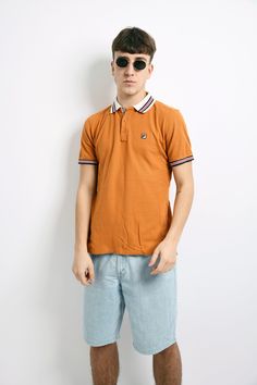 "FILA vintage polo shirt men's in orange. Size - US XS, UK/F/I S, D 48. Model is 180 cm / 5ft 11\" tall and usually wears size M. Very good vintage condition. Flat measurements: Length - 26.3\" / 67 cm; Pit to pit (chest) - 19.3\" / 49 cm. All orders are shipped every day Worldwide from EU. Safe registered standard delivery Worldwide with courier and tracking number. Free delivery from €80/$92! We are also sending with very fast Express delivery (UPS). Just choose shipping upgrade in your cart. Sporty Polo Collar T-shirt For Summer, Sporty Polo Collar Top For Summer, Summer Streetwear Polo Collar Top, Summer Polo Collar Top For Streetwear, Summer Polo Collar T-shirt For Streetwear, Summer Polo Shirt For Streetwear, Yellow Collared Polo Shirt For Summer, Brown Cotton Polo Shirt For Summer, Yellow Polo Shirt With Collar For Summer