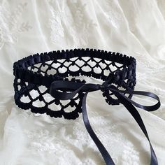 This black crochet lace choker necklace is tied with a black satin ribbon. A simple yet elegant accessory that will work well with a lot of looks. The choker is similar to the Victorian lace collar. Teenagers, who prefer clothes in the Gothic style, also like to wear them to emphasize their individuality. The choker can be used as an additional accent for creating costumes for Cosplay. Made from 100% high-quality mercerized cotton. Choker lenght 34 cm / 13,4 inches, width - 4 cm / 1,5 inches. Wh Adjustable Black Ribbon Party Choker, Adjustable Lace Choker For Party, Elegant Black Lace Choker, Black Ribbon Choker For Party, Elegant Adjustable Lace Choker, Black Ribbon Choker As A Gift, Lace Choker With Lace Trim For Parties, Black Ribbon Choker Gift, Black Ribbon Choker For Gifts