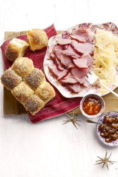 the platter is full of meats, cheese and bread