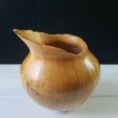 a wooden vase sitting on top of a table