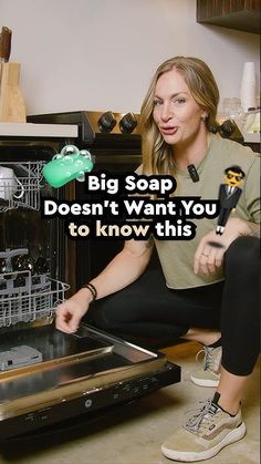 a woman sitting in front of an open dishwasher with the words, big soap doesn't want you to know this