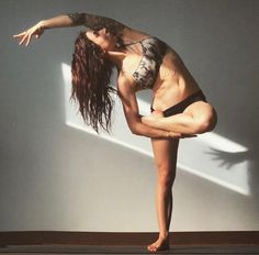 a woman is doing yoga on the floor