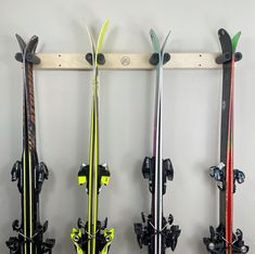 three skis are hanging on the wall next to each other