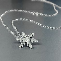 Hand formed Snowflake pendant in solid sterling silver. This snowflake is just over 5/8 inch (17mm) on a lacy sterling silver curb link chain. Choose 16 or 18 inches. The mannequin is Life Size to show the actual scale of the necklace. Pictured is the 16 inch chain I also make a ring with the same snowflake design in a slightly smaller size; https://www.etsy.com/listing/171287395/snowflake-ring-in-sterling?ref=shop_home_active_4&frs=1 Snowflake Ring, Snowflake Necklace, Snowflake Pendant, Snowflake Design, Silver Snowflakes, Snowflake Designs, Hammered Silver, Life Size, Link Chain