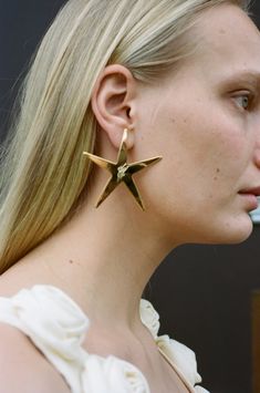 A pair of large star earrings.    eyland    gold    100% 18ct yellow gold plated brass    for pierced ears    diameter approx 6cm    made in jaipur Gold Star-shaped Hoop Earrings For Party, Gold Star Hoop Earrings For Party, Brown Slip Dress, Military Star, Joah Brown, Easy Tiger, Black Crane, Silk Tank, Delicate Jewelry