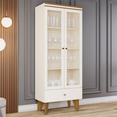 a tall white cabinet with glass doors in a living room next to a gray wall