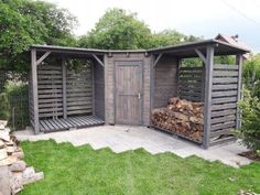 an outdoor firewood storage shed with logs stacked in the back and doors open on either side