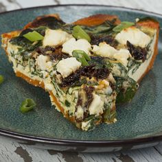 a slice of vegetable quiche on a blue plate