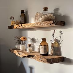 two wooden shelves with bottles and vases on them