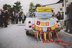 an old car with luggage strapped to it's back