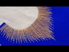 a piece of cloth with gold thread on it