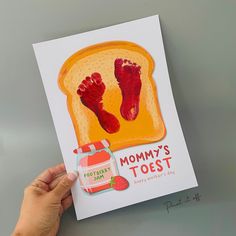 a hand holding up a card that says mommy's toast with strawberry jam on it