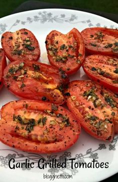 grilled tomatoes on a plate with herbs