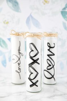 three personalized candles tied with twine