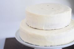 two white cakes sitting on top of each other