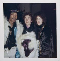 three people standing next to each other with fur on them