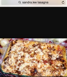 a casserole dish with meat and cheese in it on a checkered table cloth