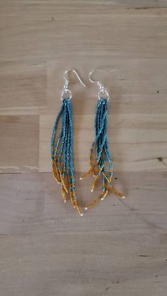 "More styles and colors here: https://www.etsy.com/shop/MeadowValleyDesignCo These fun, colorful earrings are a great addition of color to any outfit! Very lightweight and eye catching! Handmade with seed beads in dark seafoam and topaz. Then completed with with silver plated, nickel free ear wire. Choose 4.5\" or 5.5\" at checkout. Measured from top of ear wire (where it hangs in your ear) to the bottom of the longest strand of beads." Crazy Crafts, Seed Bead Bracelet Patterns, Beads Craft Jewelry, Stick Earrings, Beaded Earrings Tutorials, Beaded Earrings Diy, Native American Beaded Earrings, Beaded Tassel Earrings, Handmade Earrings Beaded