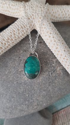 "Oval chrysocolla cabochon pendant.  Set in a handcrafted sterling silver bezel setting.  18\" sterling silver chain." Oval Chrysocolla Necklace With Natural Stones, Turquoise Chrysocolla Oval Pendant Necklace, Oval Chrysocolla Necklaces As Gifts, Oval Chrysocolla Necklace Gift, Oval Chrysocolla Necklace As A Gift, Chrysocolla Oval Pendant Necklace As Gift, Chrysocolla Oval Pendant Necklace For Gifts, Oval Pendant Chrysocolla Necklace For Gift, Silver Chrysocolla Necklace With Large Stone