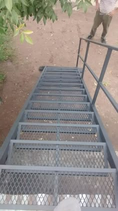 a man standing on top of a metal ramp