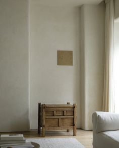 a living room with a white couch and wooden table