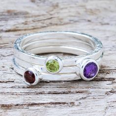 Designed to mix and match three stacking rings enclose the colors of spring. Jantana works in sterling silver to create solitaires in amethyst garnet and peridot. They can be worn together or separately. .925 Sterling silver Amethyst Stackable Rings, Spiritual Adjustable Stackable Birthstone Rings, Multicolor Sterling Silver Stackable Rings, Spiritual Stackable Amethyst Jewelry, Adjustable Stackable Amethyst Rings, Contemporary Jewelry Design, Stacking Ring Set, Gem Ring, Peridot Ring