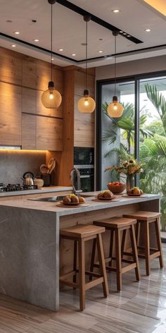 a kitchen with an island and three stools in front of the counter top that is made out of wood