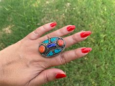 This listing is for 1 piece. At wholesale price Large Tibetan Rings with Turquoise, Coral & Lapis Inlay is absolutely stunning with beautiful adjustable band. You will receive the exact ring shown in the pictures.This high quality durable statement piece ring is handmade in Nepal. Beauty of this ring that is unmatched as they are handmade and are one of a kind. With the nature of them being handmade, each product is unique in its own right and no two products are the exact same. Made with Ti Bohemian Multicolor Rings For Festival, Adjustable Multicolor Turquoise Bohemian Ring, Bohemian Oval Multi-stone Turquoise Ring, Bohemian Multicolor Rings For Jewelry Making, Bohemian Multicolor Gemstone Rings, Multicolor Bohemian Gemstone Rings, Multicolor Natural Stones Turquoise Ring In Bohemian Style, Multicolor Natural Stones Turquoise Ring Bohemian Style, Multicolor Natural Stones Turquoise Bohemian Ring