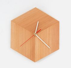 a wooden clock with two hands on it