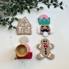 three small gingerbreads are on the table next to a pot holder