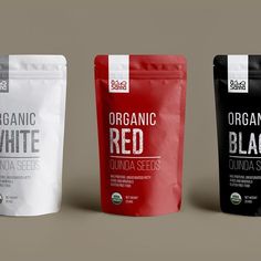 three bags of organic red, white and black seeds on a gray background with the packaging printed out