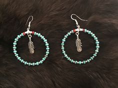 Authentic Beautiful Navajo Zuni oversized hoop earrings with Sleeping Beauty Turquoise and Sterling Silver balls with Feather  Handcrafted by Navajo Artist Harriet Crosby Great for a Gift ❤️ Earrings are 2" Hoops.  Hoop Earrings are SO popular right now.. These are perfect for Hoop Lovers! They are large enough to be seen from a far. Perfect hoops to go with Jeans and Boots! Southwestern Style Beaded Dangle Hoop Earrings, Nickel-free Bohemian Beaded Hoop Earrings, Nickel-free Bohemian Hoop Beaded Earrings, Bohemian Nickel-free Beaded Hoop Earrings, Bohemian Circle Jewelry With Dangling Beads, Bohemian Circular Jewelry With Dangling Beads, Handmade Southwestern Turquoise Hoop Earrings, Southwestern Turquoise Hoop Earrings For Gift, Southwestern Turquoise Hoop Earrings As Gift