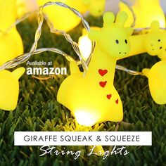 giraffe squeak and squeezeeze string lights are on the grass