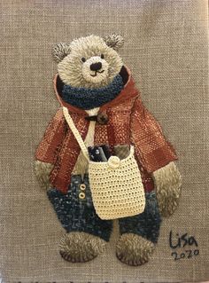 a teddy bear is holding a purse on a piece of fabric