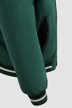 Characterized by a precious leather monogram patch, this bomber jacket draws inspiration from the collegiate-style found in the men's collection. The style is crafted from micro soft with a warm down-filling and knit, striped trim. Luxury Green Varsity Jacket, Luxury Green Nylon Windbreaker, Moncler Dingyun Zhang, Craig Green Moncler, Moncler Windbreaker, Collegiate Style, Warm Down, Men's Collection, Down Jacket