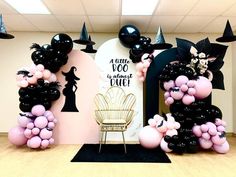 balloon decorations in the shape of cats and mice for a halloween themed party with black, pink, and white balloons