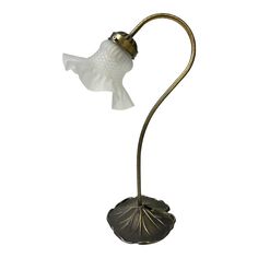 a gold fish lamp with a white glass shade on it's head and body