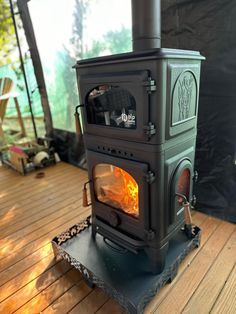 a wood stove sitting on top of a wooden floor