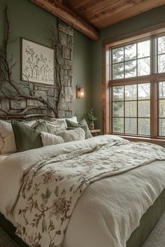 a large bed sitting under a window next to a stone wall in a room with green walls